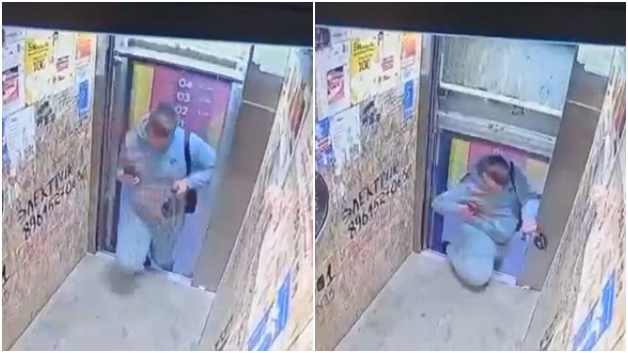 俄男掛住睇手機，險被升降機「斬首」。(Telegram)