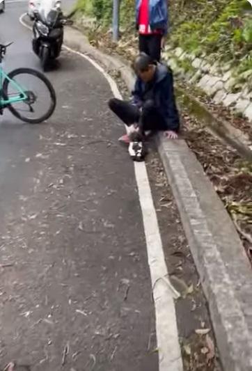 死者事後曾以手按住腹部坐在路邊。(網片截圖)