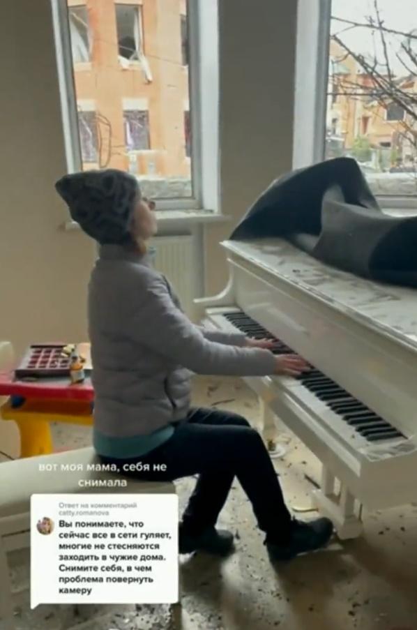 女子在滿布碎片的大廳、破爛的窗前彈奏起動人樂曲。(Twitter)