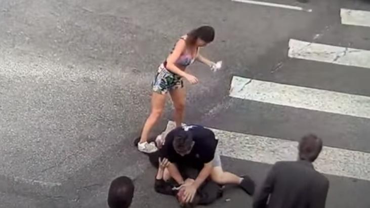 女子索性踩在匪徒的腳上。(YouTube)