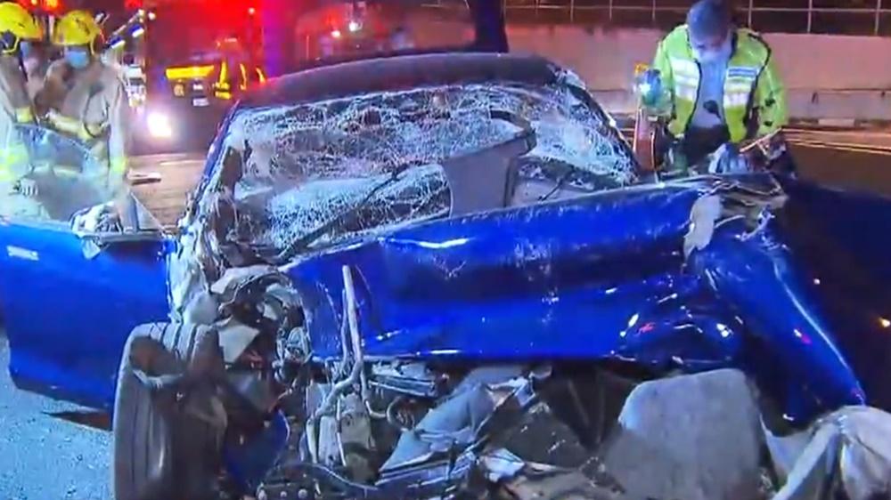 涉事Tesla懷疑失控撞向停泊於上址的箭嘴車,3名工人受傷。(電視截圖)