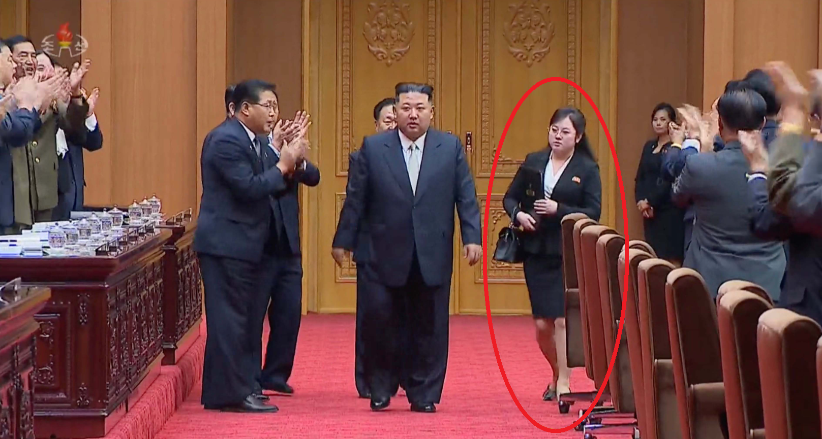 金正恩出席最高人民會議(SPA)大會時,神秘女子亦隨行,手中拿著印有朝鮮勞動黨中央委員會標誌的文件夾。(互聯網)