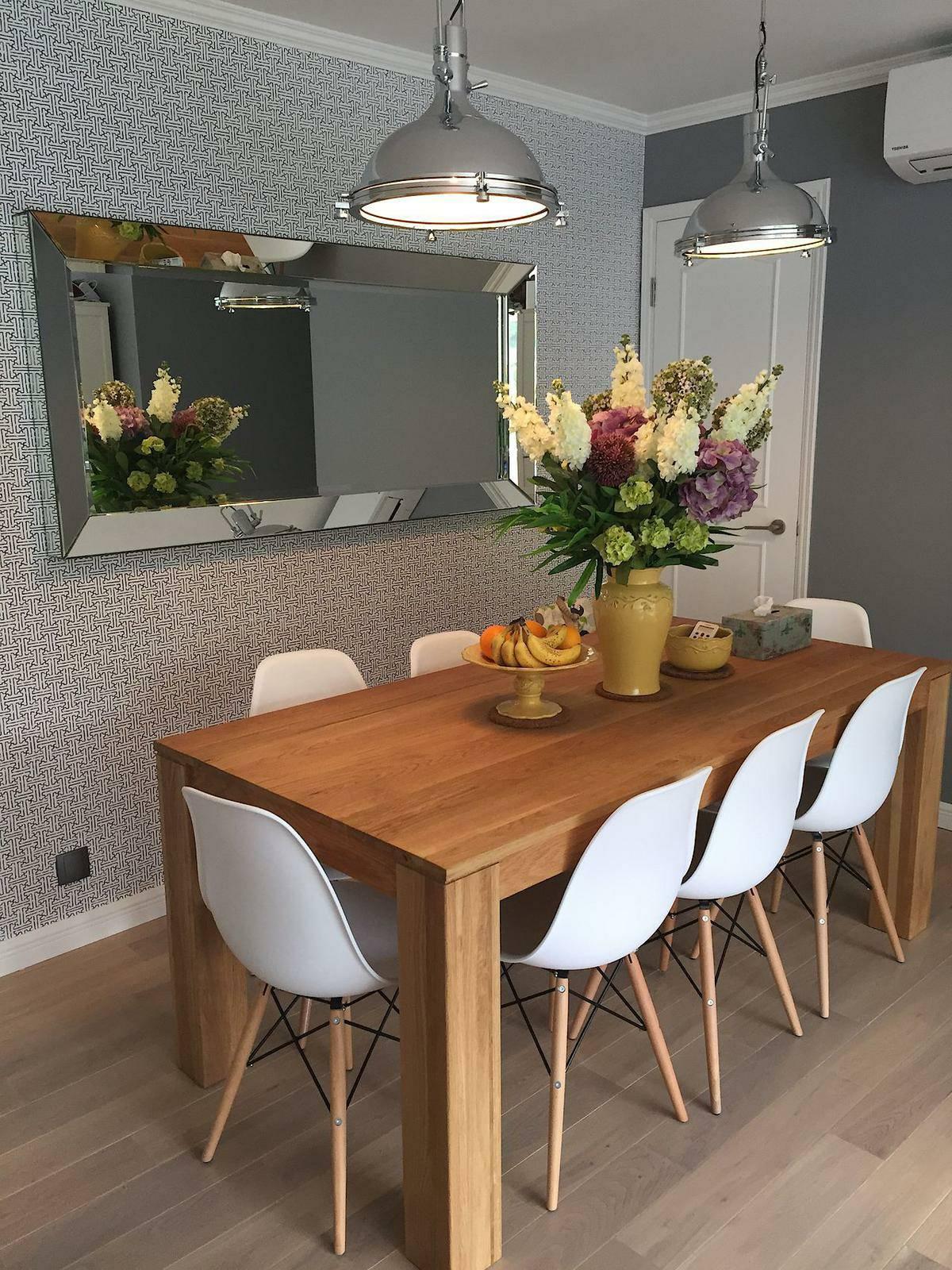 八人木製餐桌放在飯廳裡,配以灰色牆紙和牆身,以及銀色工業風吊燈,將簡約和型格風格合二為一。