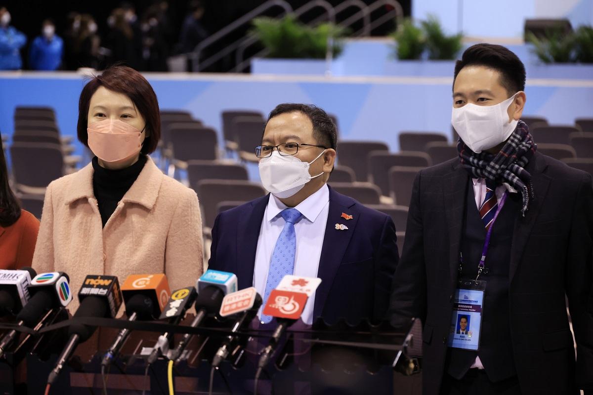 陳永光(中)被傳媒以英語提問入議會後的抱負時,先後由李慧琼(左)和周浩鼎(右)代為回應。(中通社)