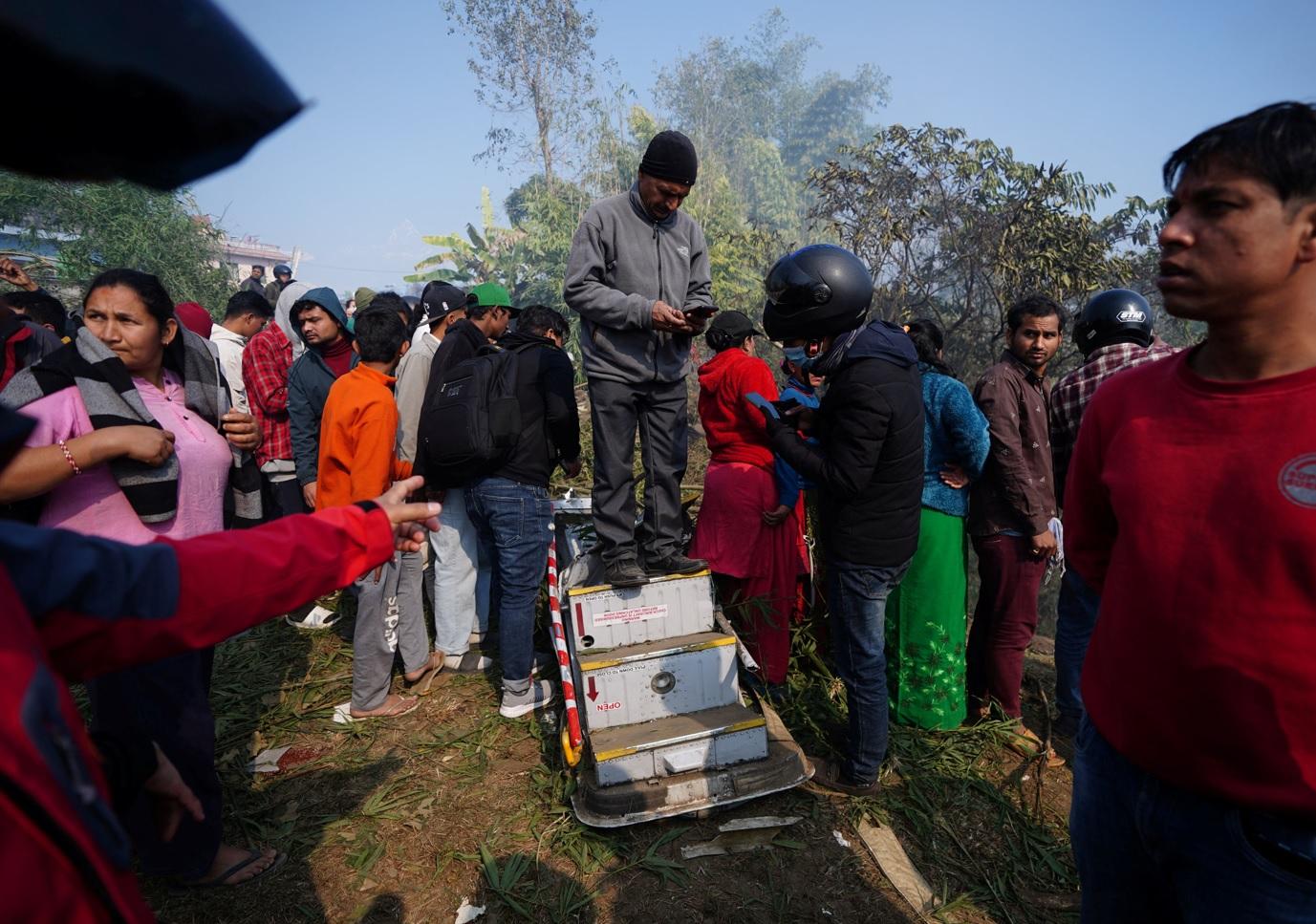 居民站在客機機梯上。(路透社)