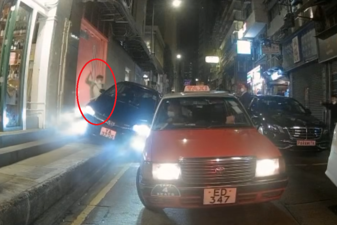 警員(紅圈)試圖打破司機位的玻璃窗。(影片截圖)