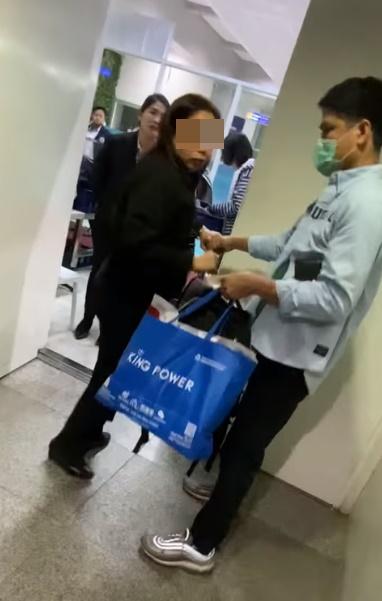 安檢人員將錢由手交回遊客手中,並請求拍攝者刪除影片。(FB)