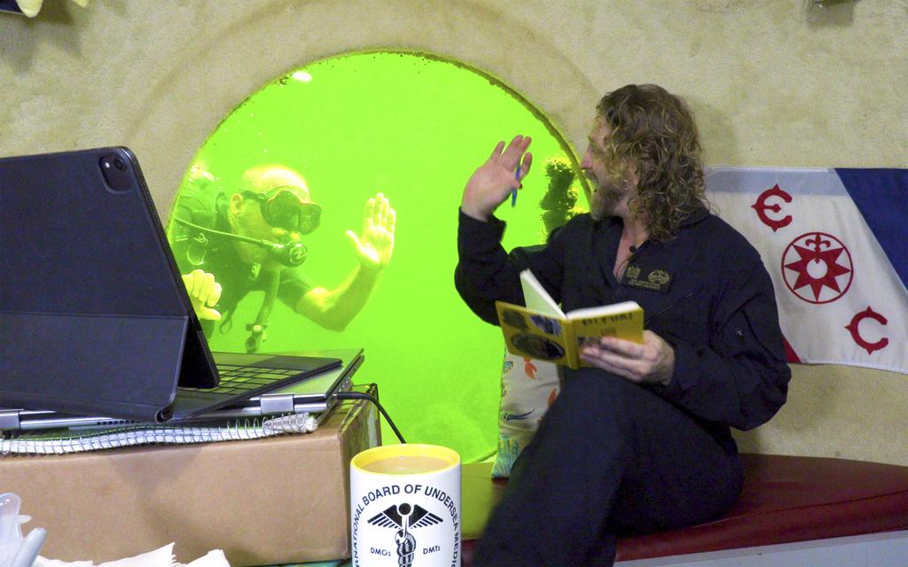 深海獨居的迪圖里與潛水員打招呼。(美聯社)