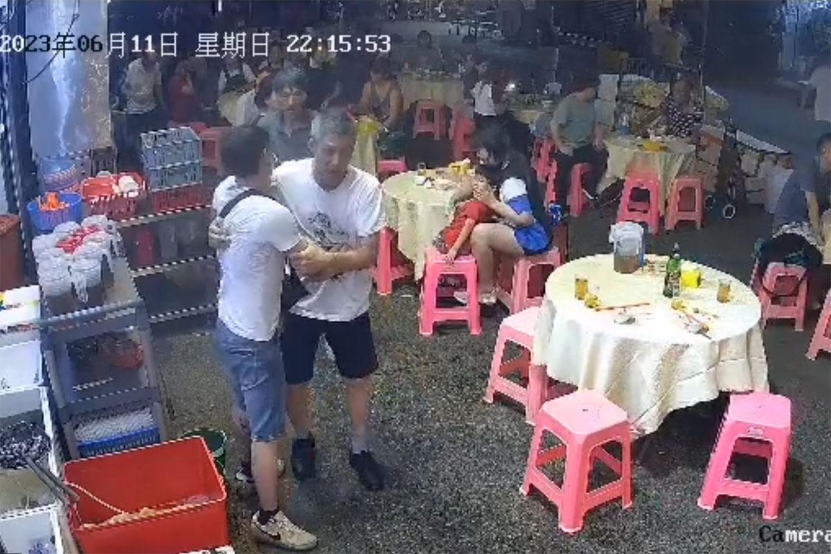 中年白衣醉漢起初指罵大排檔內一對母子,店員勸阻無果。(網上片段截圖)