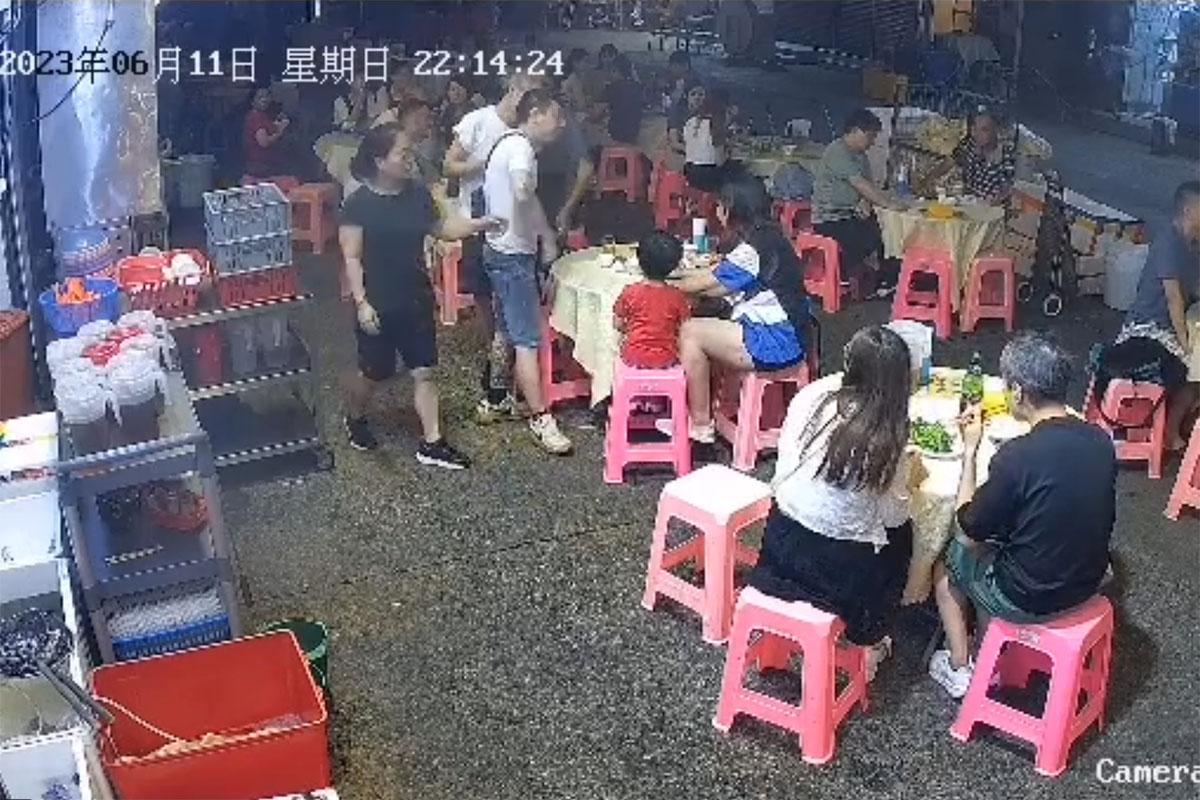 中年白衣醉漢起初指罵大排檔內一對母子,店員勸阻無果。(網上片段截圖)