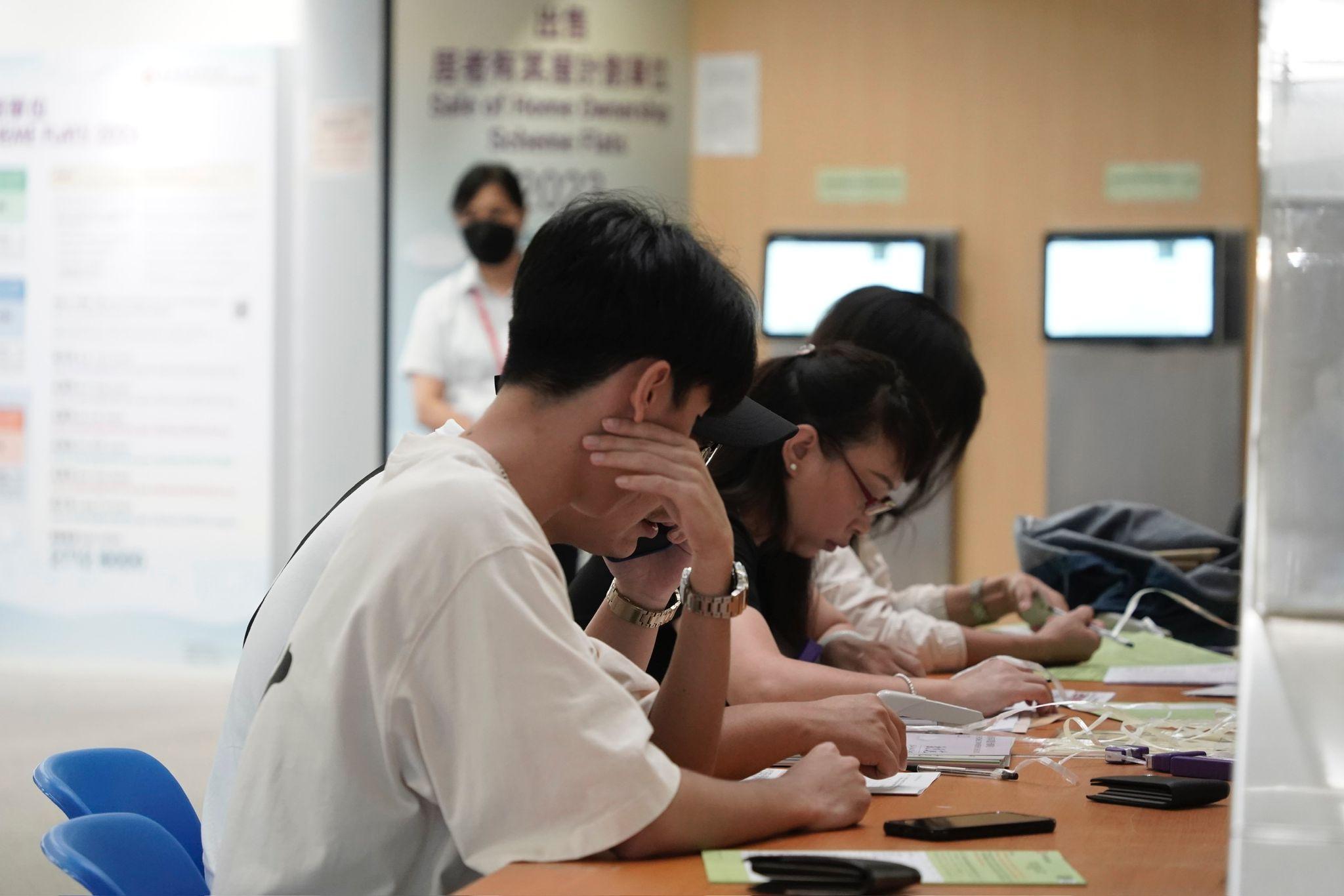 居屋2023|新一期居屋及「白居二」今起接受申請,不少市民在樂富房委會早上8時開門前已經到場排隊領取表格及交表。(陳國峰攝)