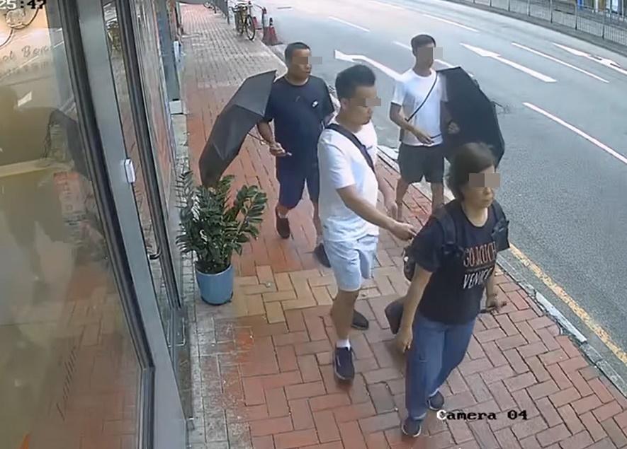 在落手男子在背嚢抽出一件物件時,女子側頭望向路經店舖的櫥窗,疑似透過櫥窗反光發現事件。(西環變幻時@FB)