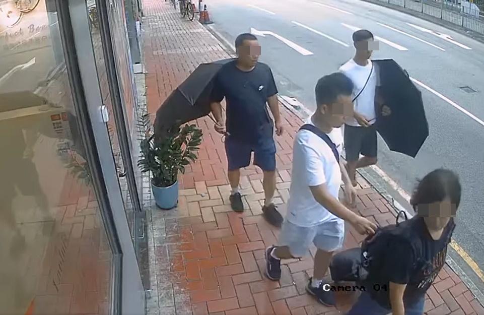 在落手男子在背嚢抽出一件物件時,女子側頭望向路經店舖的櫥窗,疑似透過櫥窗反光發現事件。(西環變幻時@FB)