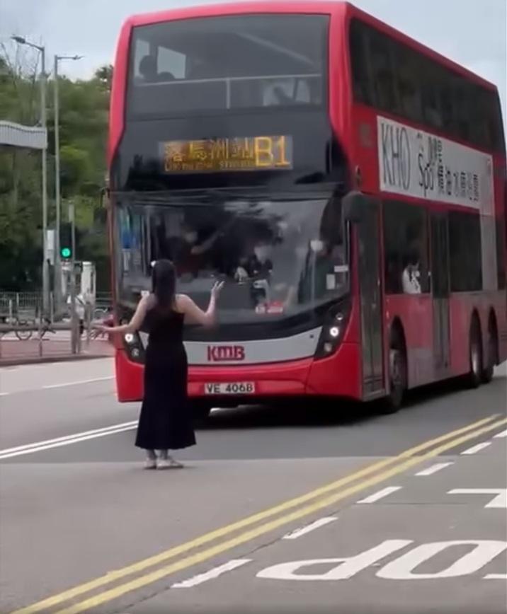 黑衣女子張開雙手,不讓一輛滿座的九巴開走。(網片截圖)