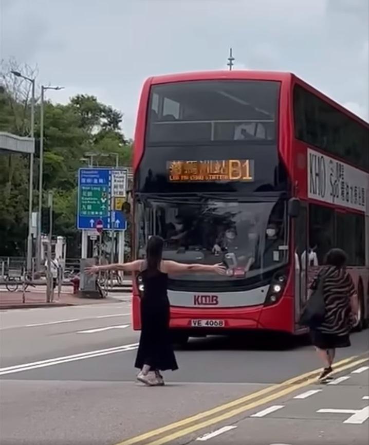 黑衣女子張開雙手,不讓一輛滿座的九巴開走。(網片截圖)
