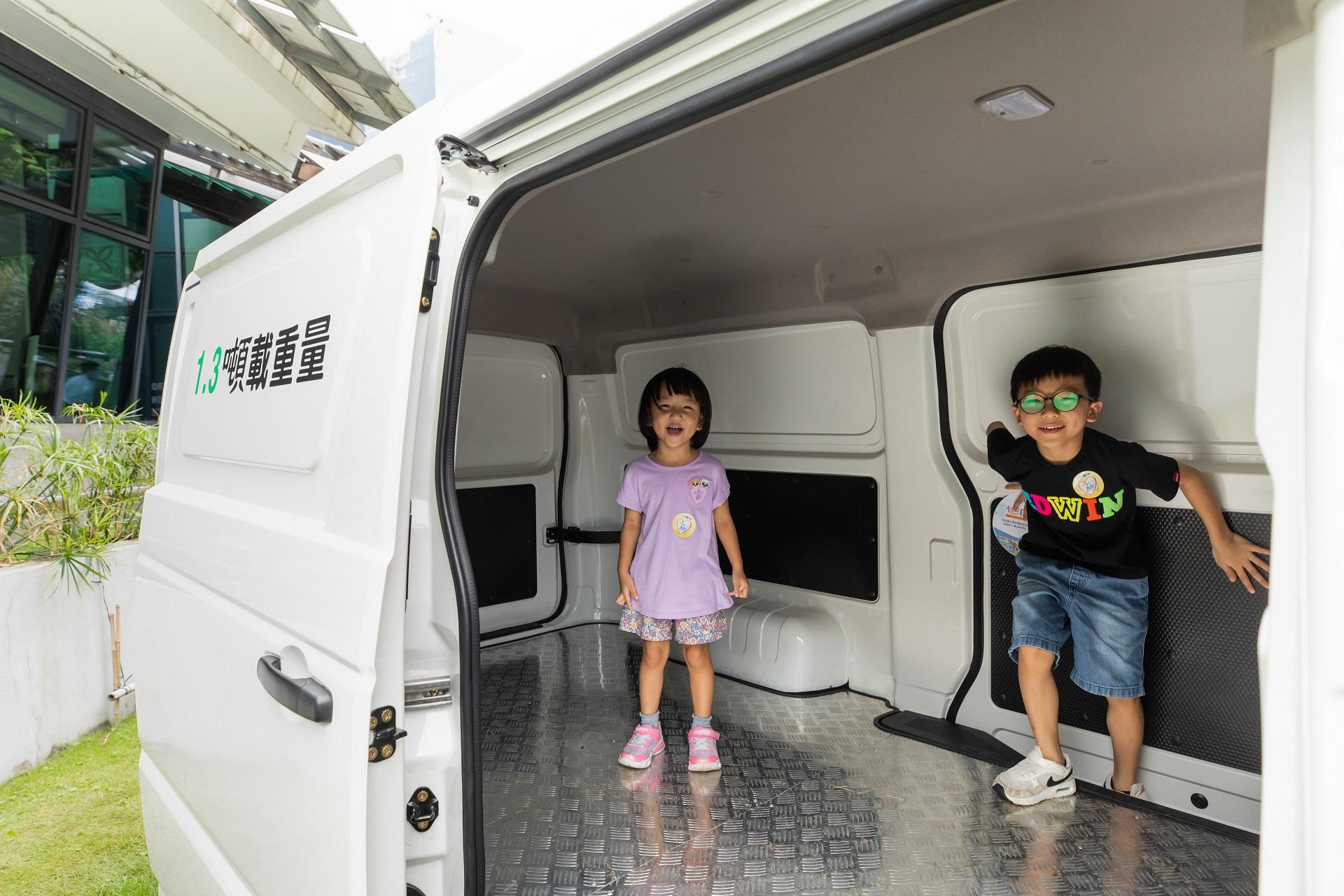 小朋友登上電動輕型貨車,玩得不亦樂乎。