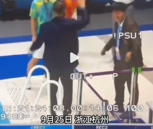 杭州亞運|游泳裁判跣腳跌入泳池中後,上水向觀眾揮手及微笑(微博截圖)