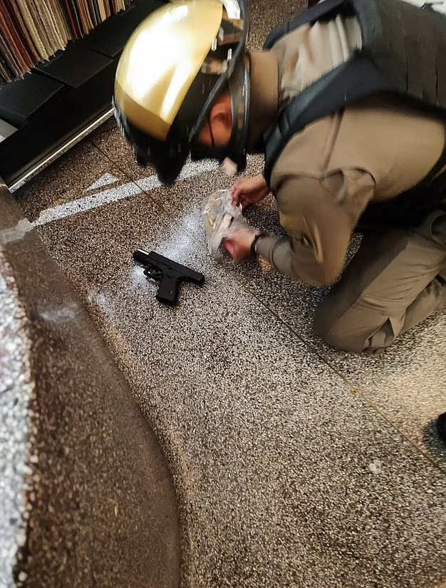 警員在現場檢獲手槍。(路透社)