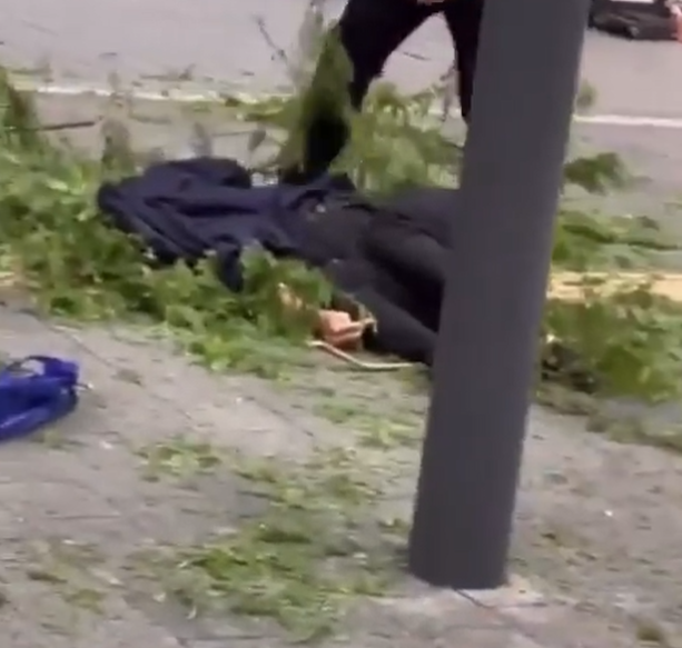 男子墮樓後,有人用西裝遮蓋頭部。(影片截圖)