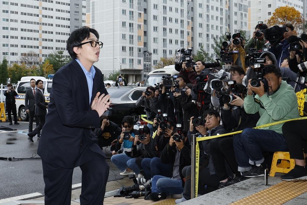 G-DRAGON涉毒現身警局助查150警恭候,近百記者圍影GD進入警局。(路透社)