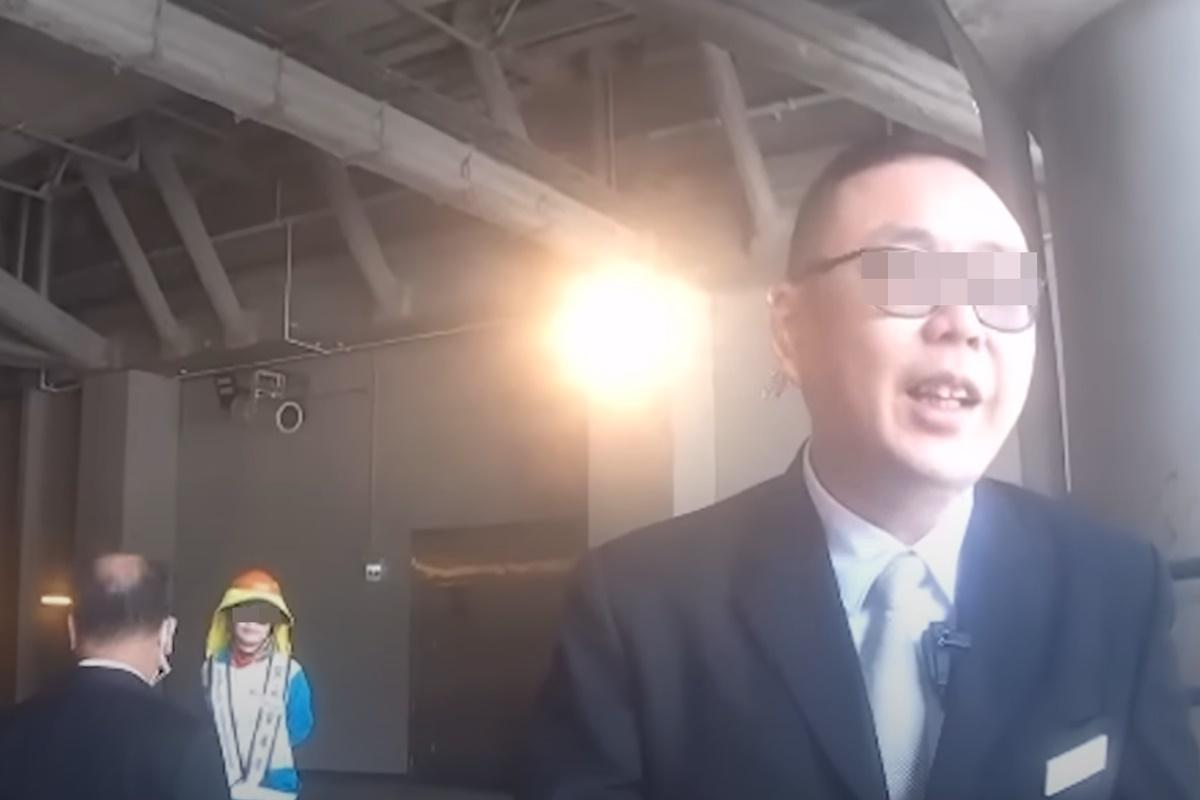 戴眼鏡的保安介入後,起初故作鎮靜並認同鐵騎士的解釋。(網上片段截圖)