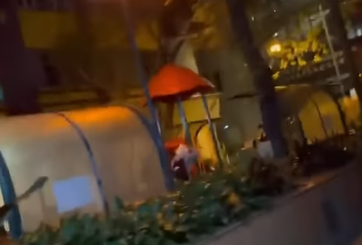 其後再有影片流出,顯示有一批人士在摩利臣山道永寧街休憩處向一名男子潑水,及後一干人逃走,有同黨有附近拍下全程,未知是否同一批人。(影片截圖)