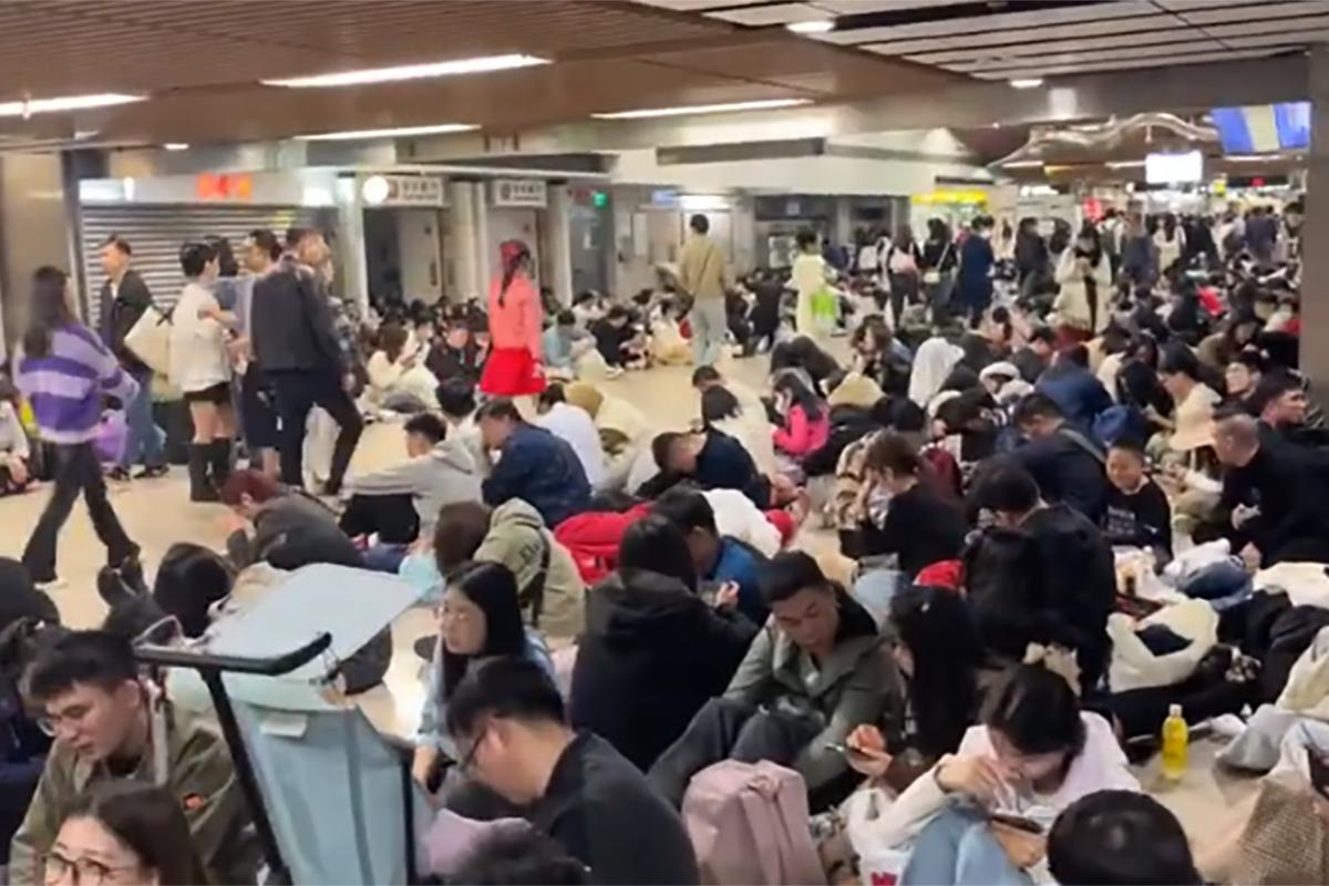 有滯留的內地旅客於港鐵上水站大堂通宵等候往羅湖的頭班車。(網上片段截圖)