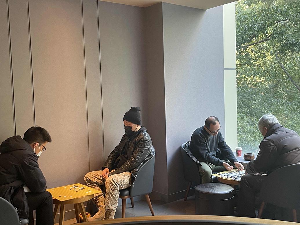 上海一間星巴克咖啡店成為圍棋愛好者對弈的好去處,二樓大部分座位常被約30多名棋友佔據,甚至有人未點餐卻「由朝玩到晚」,店方對此提出兩大要求,包括下棋時保持安靜,並希望大家能盡量點餐。(澎湃新聞圖片)