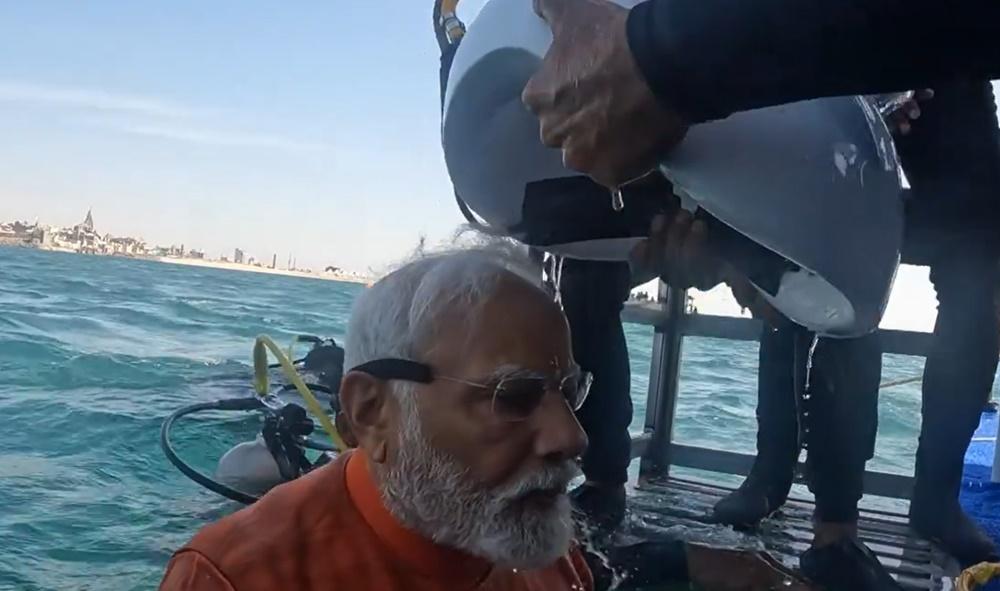 莫迪返回水面,由助手為其移除頭盔形呼吸器。(X)