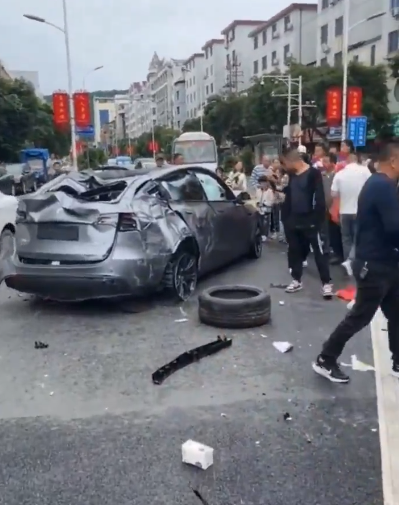 江西贛州一輛Tesla Model Y電動車行駛時,疑因緊急避讓行人操作不當,撞上道路設施和停在路邊的車輛,車輛凌空飛起,翻滾多圈砸壞路上約9輛車,造成4人受傷。(影片截圖)