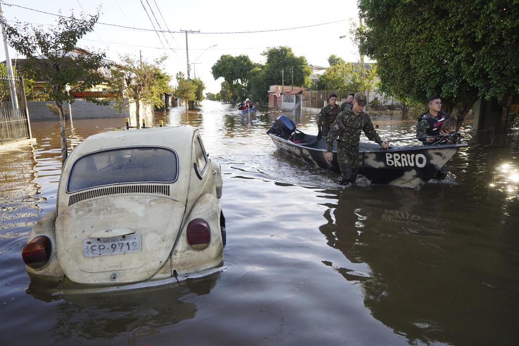 巴西南大河州水災持續,軍人拯救受困狗隻。(美聯社)