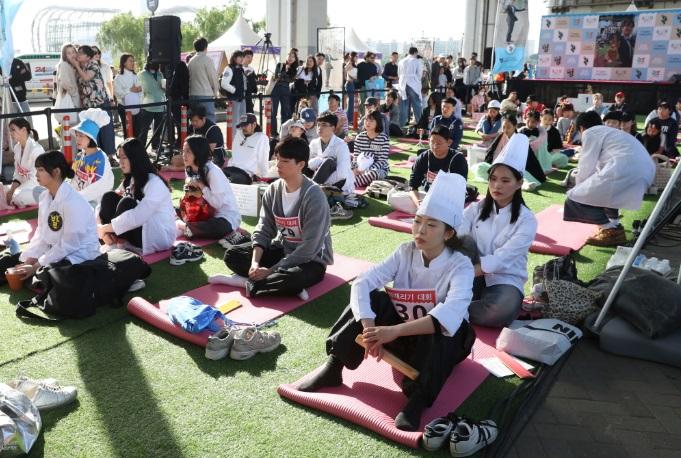 南韓年度發呆大賽在首爾盤浦漢江公園潛水橋邊舉行,參賽者以奇特造型吸引人。(新華社)