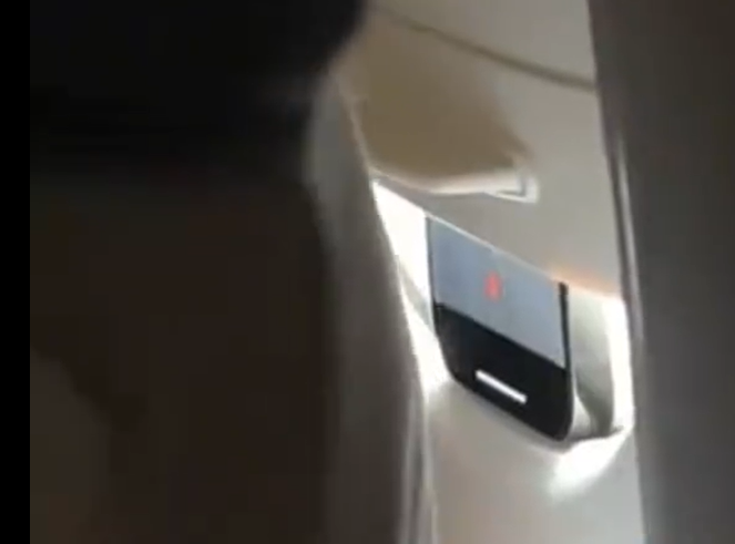 浙江省義烏市一架飛往北京市的客運航班上,有民眾目睹前排一名外國乘客將手機卡在遮光板,疑似偷拍軍民合用的機場,隨即他向國安部門舉報。(影片截圖)