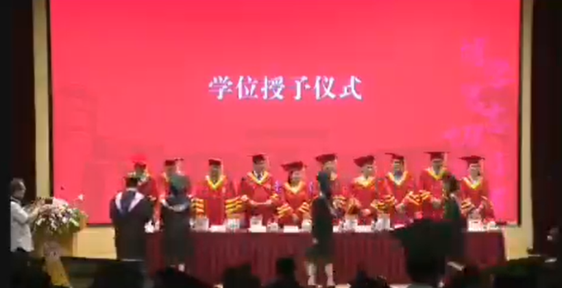 一名上海復旦大學學生在法學院畢業典禮上台時揮拳打一名教授(影片截圖)