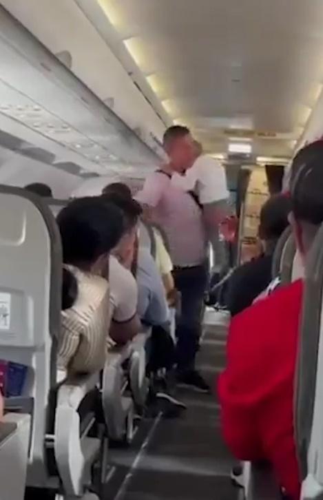 保安將該男童及其父親帶離飛機。(網上圖片)