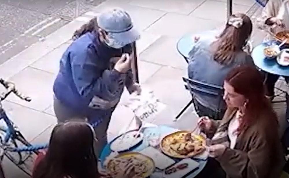 其實口罩女在用右手指向餐點的時候,左手已用標語牌覆蓋手機,同時用其他手指夾住手機偷偷帶走。(YouTube)