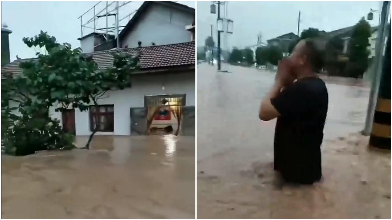 湖南常德遭遇大暴雨,居民區被淹,一名男子站在洪水中呼喚親友的視頻在互聯網熱傳。(網片截圖)
