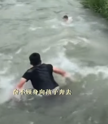 河北保定一名男孩於河邊滑倒被激流捲走,橋上一名大叔奮不顧身跳入水中,以「攔網式」將男孩救起。(影片截圖)