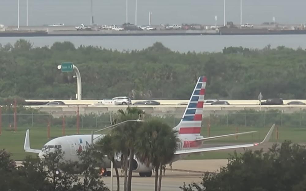 飛機緊急停下,可見右邊輪胎起火,緊急車輛隨後迅速趕到現場,向起火輪胎射水。(YouTube)