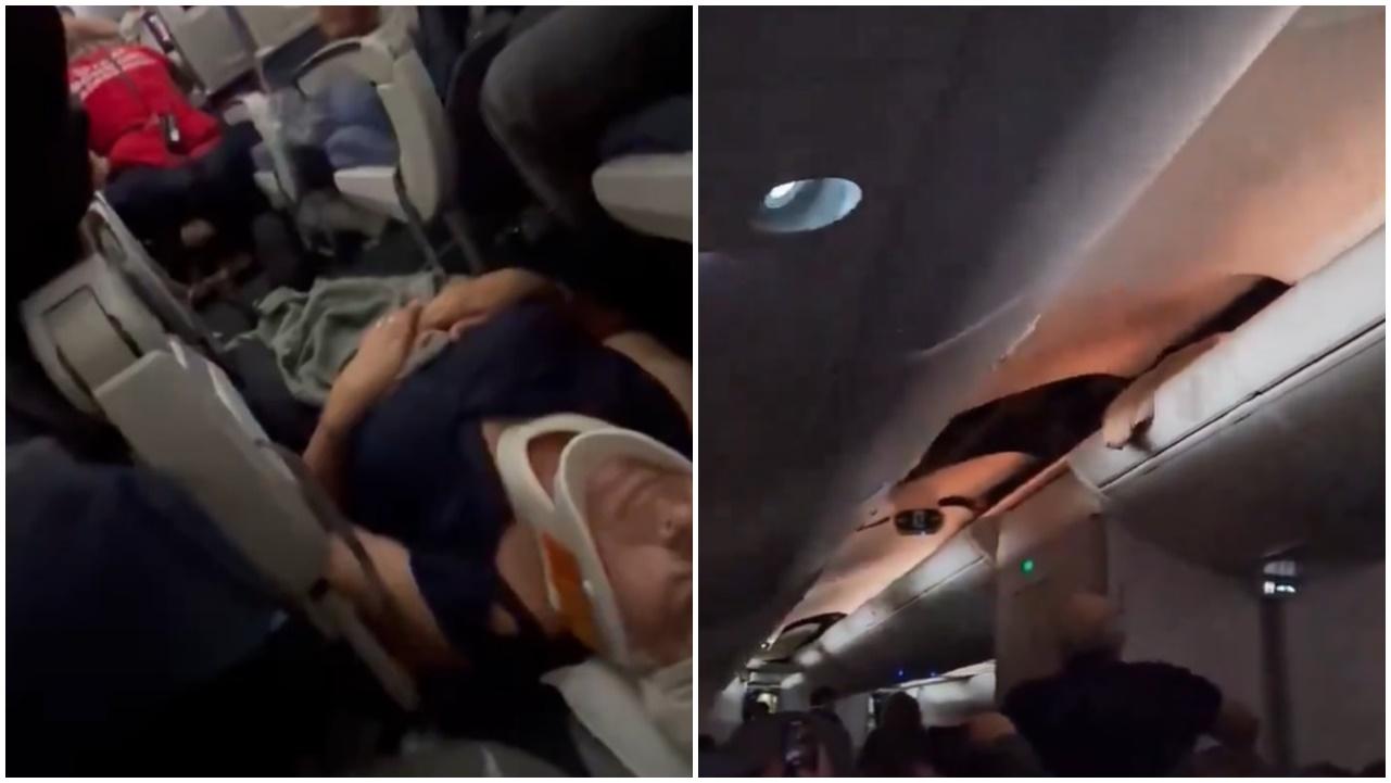 有傷者被固定頸部躺在機艙地上,假天花上有破窿。(X)