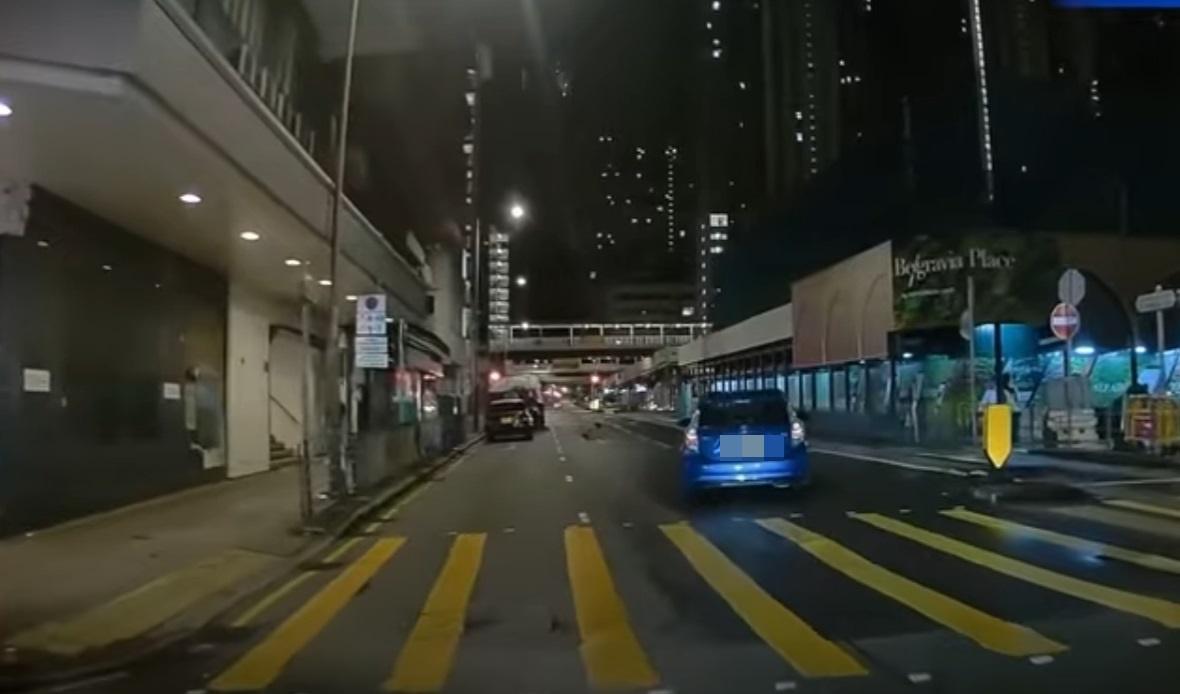 車Cam直擊|神秘男子晚間半蹲在馬路上。(網片截圖)