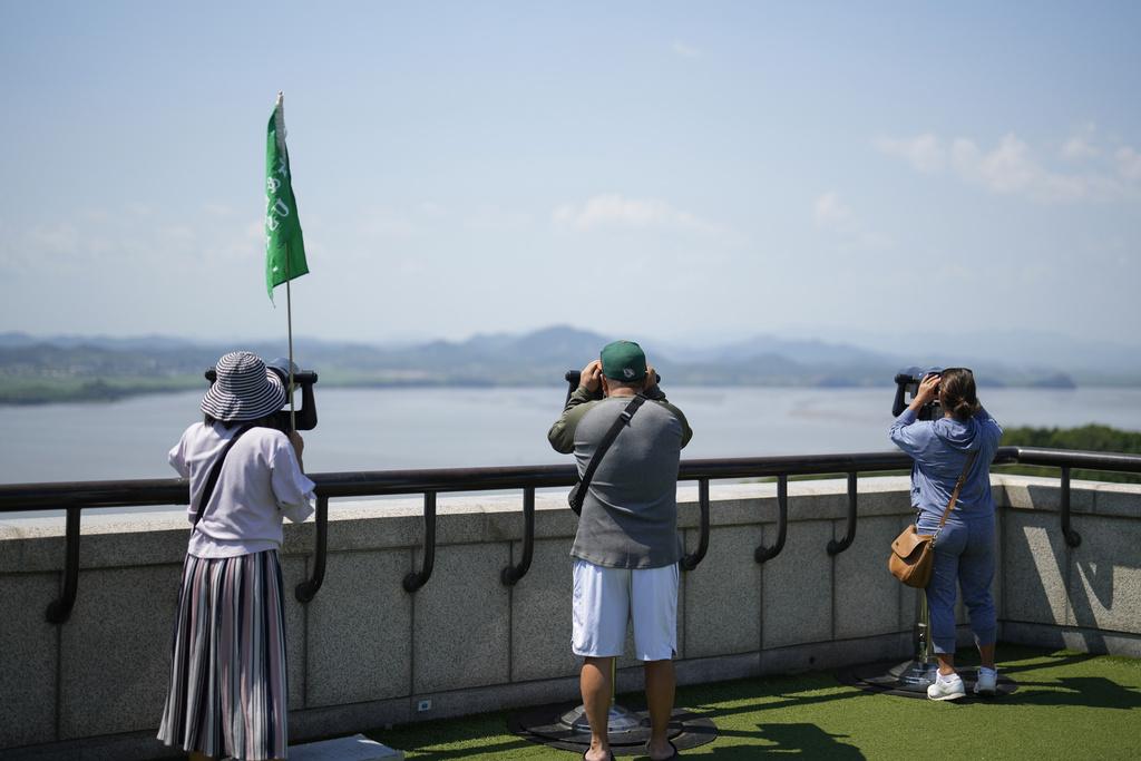 民眾在南韓玻州市邊境瞭望台用望遠鏡觀察對面的北韓邊境。(美聯社)