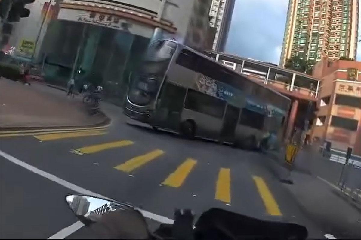 一輛九巴逆線駛入源順圍,險撞到燈位前的電單車。(網上影片截圖)
