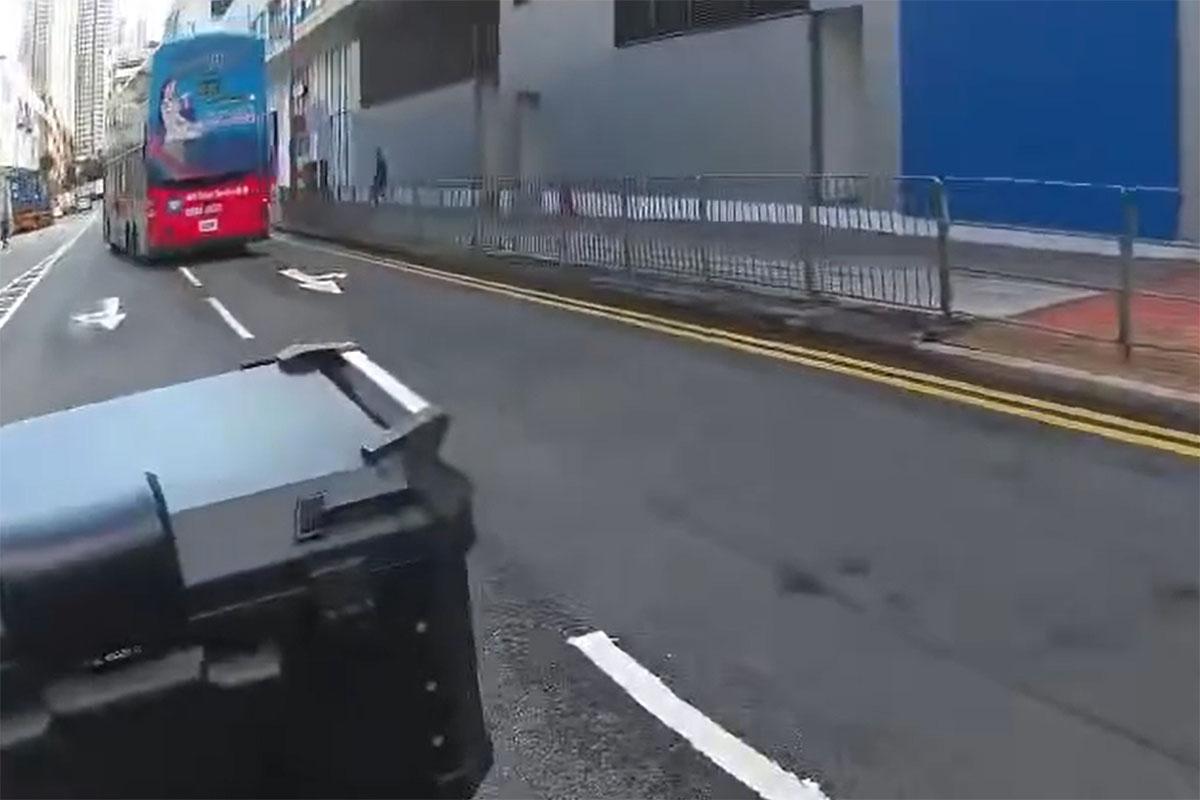 一輛九巴逆線駛入源順圍,險撞到燈位前的電單車。(網上影片截圖)