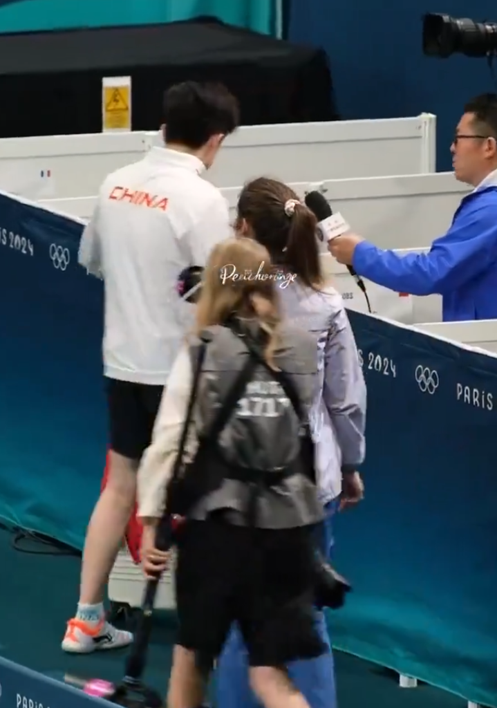 王楚欽出局後接受內媒訪問,離開訪問區時被一名持相機的女攝影記者迎面而至撞倒,對方未有表歉意繼續向前走,王楚欽流露一臉不滿表情,但未有「爆發」無奈離開。(影片截圖)