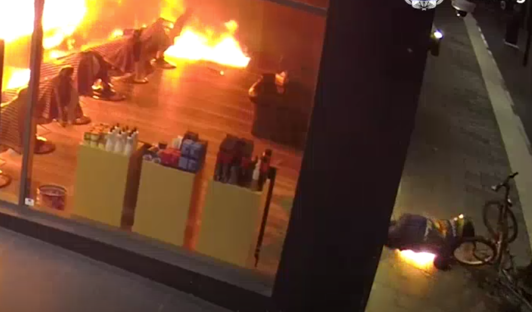 澳洲坎培拉兩男潛入一間髪型屋內縱火,其中一人淋油時火勢瞬間燒至自己身上,立刻衝出店外翻地打滾,及後與同伴狼狽離開,警方正通緝二人,又指幸好事件沒釀傷亡。(影片截圖)