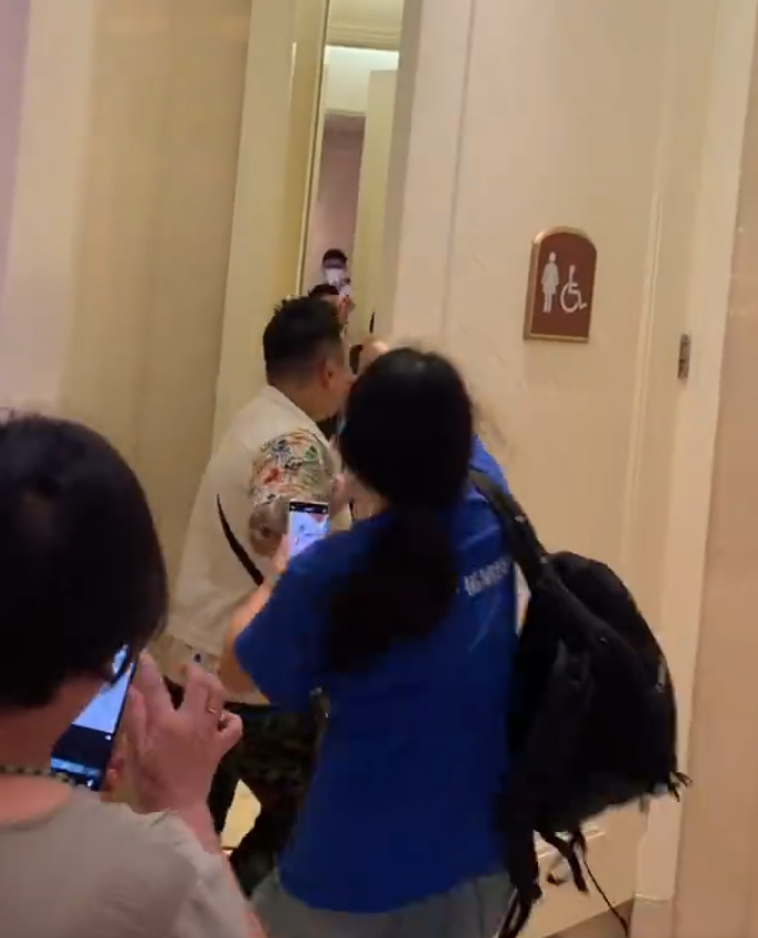 其中一名舉起手機拍攝的男子更直接開門衝入女廁(影片截圖)