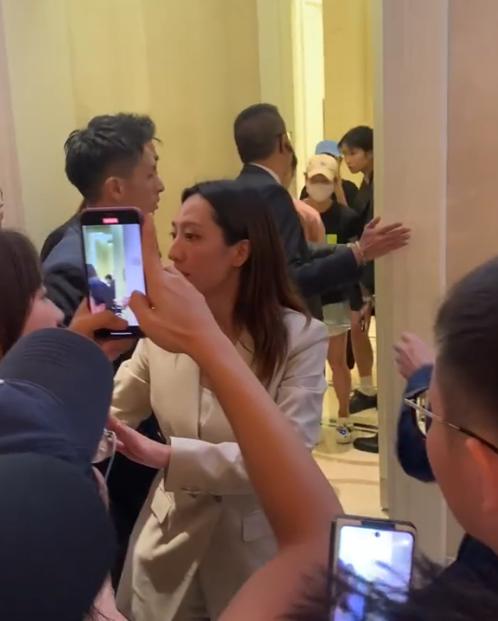 保安組成人鏈,成功護送全紅嬋離開,可見當時她拖着前方一名疑似國家隊女工作人員的手,最終全紅嬋成功前往電梯大堂回房(影片截圖)