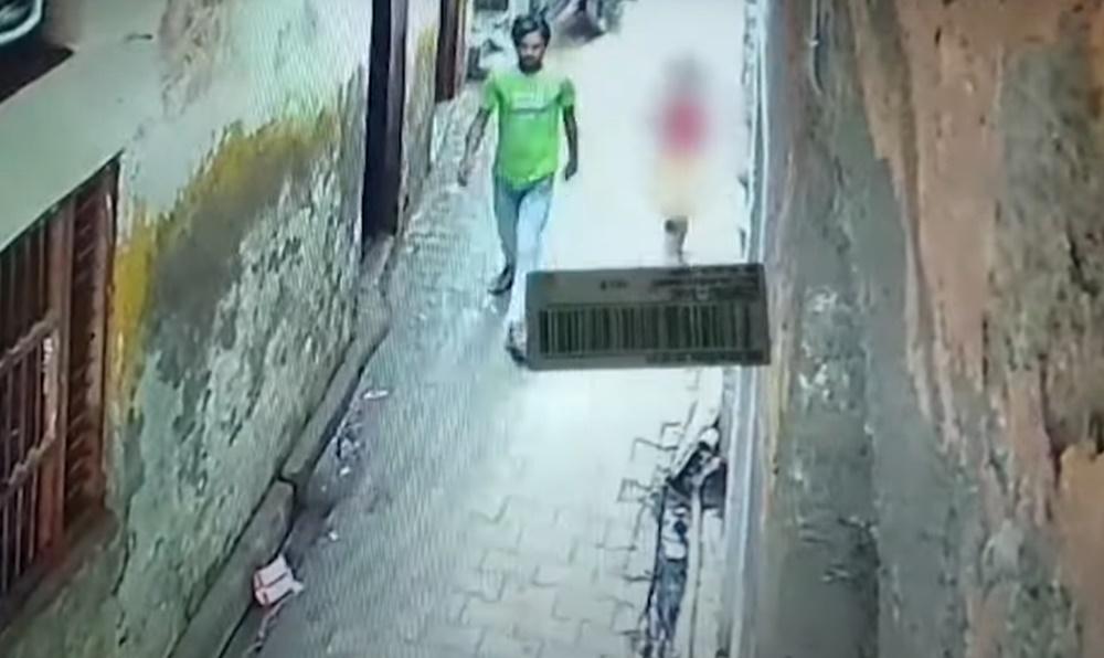 男子帶著女童,走入一條偏僻窄巷。(YouTube)