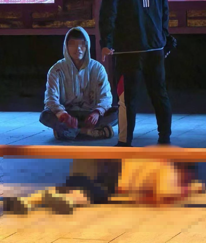 女子已倒在血泊中,其後男生被制服(影片截圖)